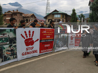 A woman is walking past Kashmiri Shiite Muslims holding banners during a religious procession on the 25th day of the Islamic month of Muharr...