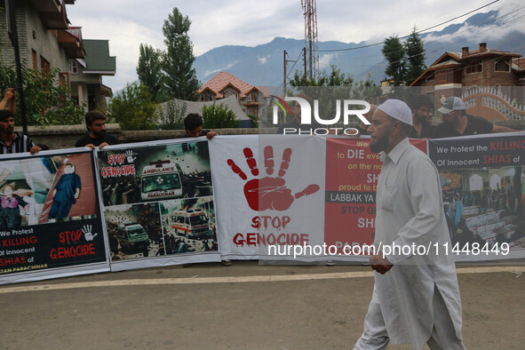 A man is walking past Kashmiri Shiite Muslims who are holding banners during a religious procession on the 25th day of the Islamic month of...