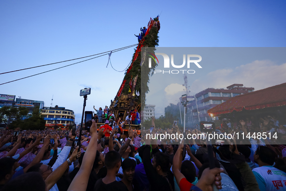 Nepali devotees are pulling the chariot of the Red God, Rato Macchindranath, to the resting point as it approaches the final tour of the cit...