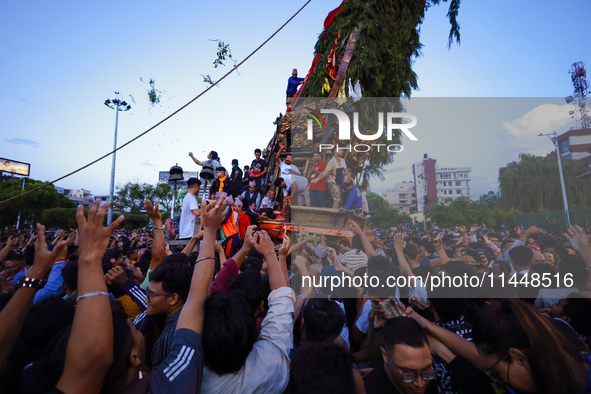 Nepali devotees are pulling the chariot of the Red God, Rato Macchindranath, to the resting point as it approaches the final tour of the cit...