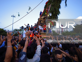 Nepali devotees are pulling the chariot of the Red God, Rato Macchindranath, to the resting point as it approaches the final tour of the cit...