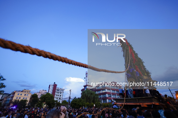 Nepali devotees are pulling the chariot of the Red God, Rato Macchindranath, to the resting point as it approaches the final tour of the cit...