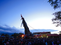 Nepali devotees are performing rituals and making offerings to the Red God, Rato Macchindranath, after it is installed at the resting point,...