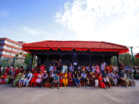 Nepali Hindu devotees are sitting on a Falcha, a public rest place, to observe the procession of the Red God, Rato Macchindranath's final to...