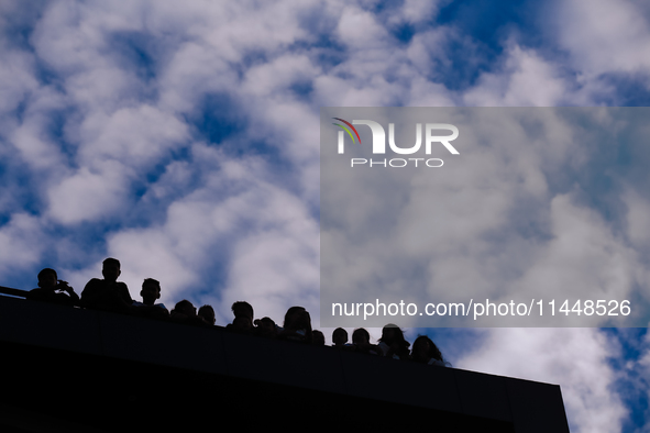 Nepali Hindu devotees are silhouetted against the sky filled with monsoon clouds as they are observing the procession of Red God- Rato Macch...