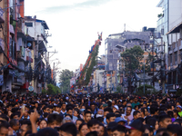 The sky-scraping chariot of the Red God, Rato Macchindranath, is wading through a sea of devotees as it approaches the final tour of the cit...