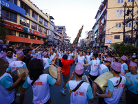 Nepali devotees are playing traditional musical instruments as the procession of the Red God, Rato Macchindranath, is approaching the final...