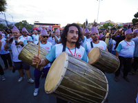 Nepali devotees are playing traditional musical instruments as the procession of the Red God, Rato Macchindranath, is approaching the final...