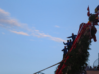 Nepali devotees are climbing up the chariot of the Red God, Rato Macchindranath, as it approaches the final tour of the city, wrapping up th...