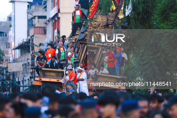 The idol of the Red God, Rato Macchindranath, is being pictured inside the sky-scraping chariot as it approaches the final tour of the city,...