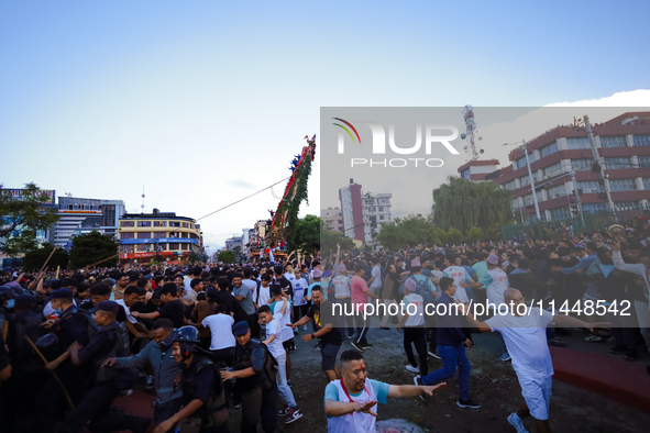 Nepali devotees are pulling the chariot of the Red God, Rato Macchindranath, to the resting point as it approaches the final tour of the cit...