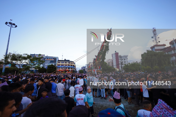 Nepali devotees are pulling the chariot of the Red God, Rato Macchindranath, to the resting point as it approaches the final tour of the cit...