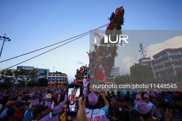 Nepali devotees are pulling the chariot of the Red God, Rato Macchindranath, to the resting point as it approaches the final tour of the cit...