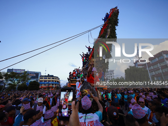 Nepali devotees are pulling the chariot of the Red God, Rato Macchindranath, to the resting point as it approaches the final tour of the cit...