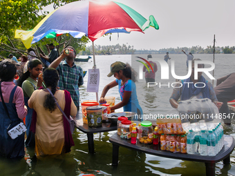 Women are preparing snacks at a small snack stand in the water along Sambranikodi Island in Kerala, India, on April 06, 2024. Sambranikodi I...