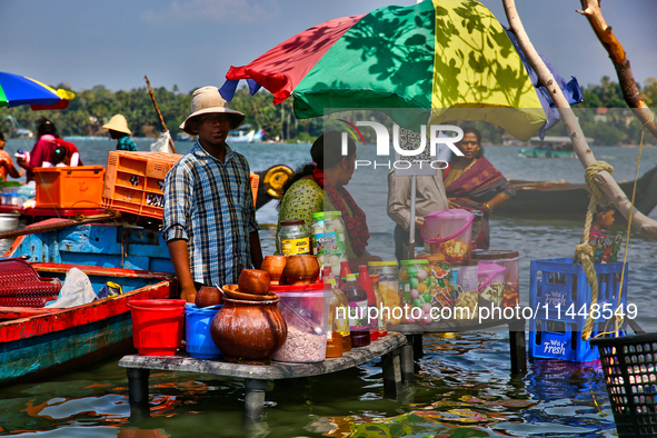 A woman is preparing snacks at a small snack stand in the water along Sambranikodi Island in Kerala, India, on April 06, 2024. Sambranikodi...