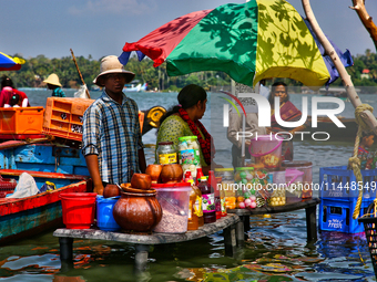 A woman is preparing snacks at a small snack stand in the water along Sambranikodi Island in Kerala, India, on April 06, 2024. Sambranikodi...