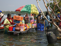 A woman is preparing snacks at a small snack stand in the water along Sambranikodi Island in Kerala, India, on April 06, 2024. Sambranikodi...