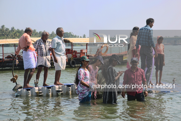 Indian tourists are standing on a small floating pier at Sambranikodi Island in Kerala, India, on April 06, 2024. Sambranikodi Island is sit...