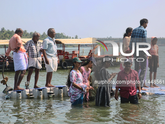 Indian tourists are standing on a small floating pier at Sambranikodi Island in Kerala, India, on April 06, 2024. Sambranikodi Island is sit...