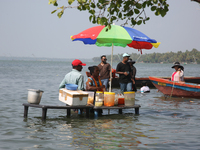 A woman is preparing snacks at a small snack stand in the water along Sambranikodi Island in Kerala, India, on April 06, 2024. Sambranikodi...