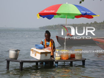 A woman is preparing snacks at a small snack stand in the water along Sambranikodi Island in Kerala, India, on April 06, 2024. Sambranikodi...