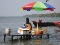 A woman is preparing snacks at a small snack stand in the water along Sambranikodi Island in Kerala, India, on April 06, 2024. Sambranikodi...