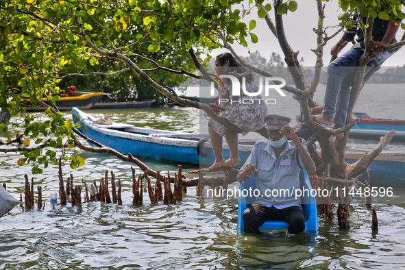 A security guard is sitting on a chair at Sambranikodi Island in Kerala, India, on April 06, 2024. Sambranikodi Island is situated at the so...