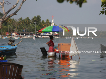 A woman is selling snacks at a small snack stand in the water along Sambranikodi Island in Kerala, India, on April 06, 2024. Sambranikodi Is...