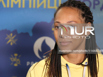 Ukrainian epee fencer Dzhoan Feybi Bezhura, who is losing 13-14 to French athlete Auriane Mallo-Breton, is being pictured upon returning fro...