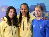 Ukrainian epee fencers Vlada Kharkova, Dzhoan Feybi Bezhura, and Olena Kryvytska (L to R) are posing for a photo upon coming back from the P...