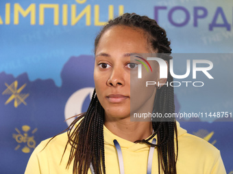 Ukrainian epee fencer Dzhoan Feybi Bezhura, who is losing 13-14 to French athlete Auriane Mallo-Breton, is being pictured upon returning fro...