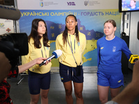 Ukrainian epee fencers Vlada Kharkova, Dzhoan Feybi Bezhura, and Olena Kryvytska (L to R) are answering reporters' questions upon coming bac...