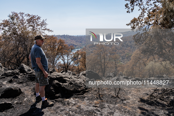 Ken Elmore is standing on his property following the aftermath of the Thompson Fire, in Oroville, Calif., on July 31, 2024. Along with his w...