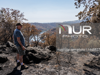 Ken Elmore is standing on his property following the aftermath of the Thompson Fire, in Oroville, Calif., on July 31, 2024. Along with his w...