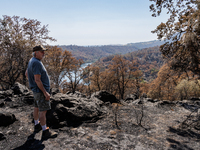 Ken Elmore is standing on his property following the aftermath of the Thompson Fire, in Oroville, Calif., on July 31, 2024. Along with his w...