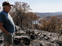 Ken Elmore is standing on his property following the aftermath of the Thompson Fire, in Oroville, Calif., on July 31, 2024. Along with his w...