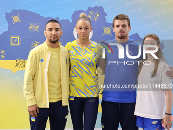 Ukrainian judokas Dilshot Khalmatov, Daria Bilodid, Bohdan Yadov, and Ukrainian artistic gymnast Anna Lashchevska (L to R) are posing for a...