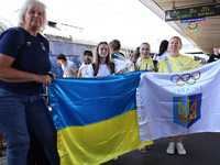 Coach Yuliia Kaiukova (center) and Ukrainian artistic gymnast Anna Lashchevska (second from left) are being pictured during the welcome cere...