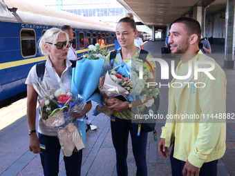 Coach Svitlana Kuznietsova, Ukrainian judokas Daria Bilodid and Dilshot Khalmatov (L to R) are being pictured during the welcome ceremony at...