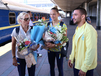 Coach Svitlana Kuznietsova, Ukrainian judokas Daria Bilodid and Dilshot Khalmatov (L to R) are being pictured during the welcome ceremony at...