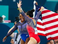 Gold medalist and winner Simone Biles of USA and bronze medalist Suni Lee are celebrating victory with the USA flag while the women's final...