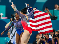 Gold medalist and winner Simone Biles of USA and bronze medalist Suni Lee are celebrating victory with the USA flag while the women's final...