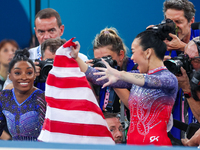 Gold medalist and winner Simone Biles of USA and bronze medalist Suni Lee are celebrating victory with the USA flag while the women's final...