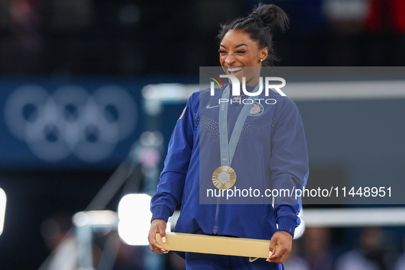 Gold medalist and winner Simone Biles of USA  poses during medal ceremony victory after the women's final all-round competition on day six o...