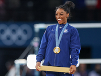 Gold medalist and winner Simone Biles of USA  poses during medal ceremony victory after the women's final all-round competition on day six o...