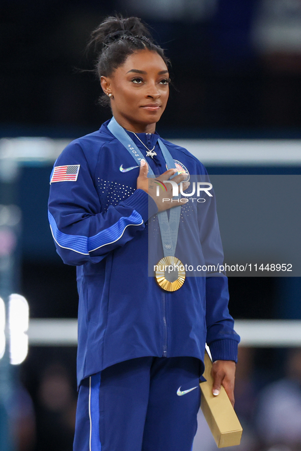 Gold medalist and winner Simone Biles of USA  poses during medal ceremony victory after the women's final all-round competition on day six o...