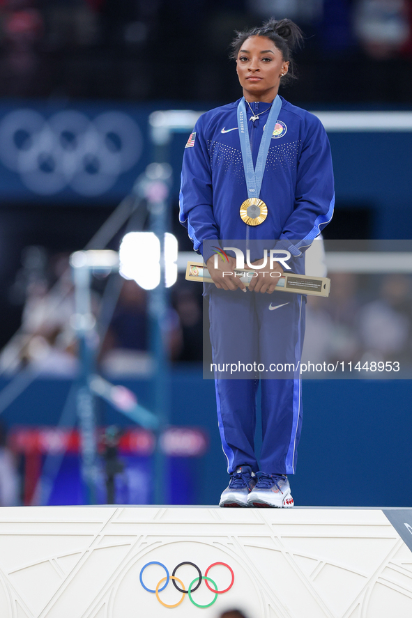 Gold medalist and winner Simone Biles of USA  poses during medal ceremony victory after the women's final all-round competition on day six o...