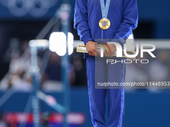 Gold medalist and winner Simone Biles of USA  poses during medal ceremony victory after the women's final all-round competition on day six o...