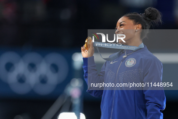 Gold medalist and winner Simone Biles of USA  poses during medal ceremony victory after the women's final all-round competition on day six o...